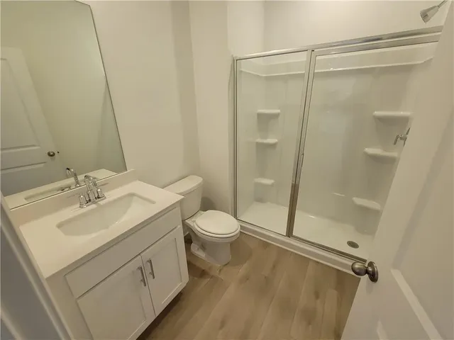 a bathroom with a double vanity sink toilet and shower