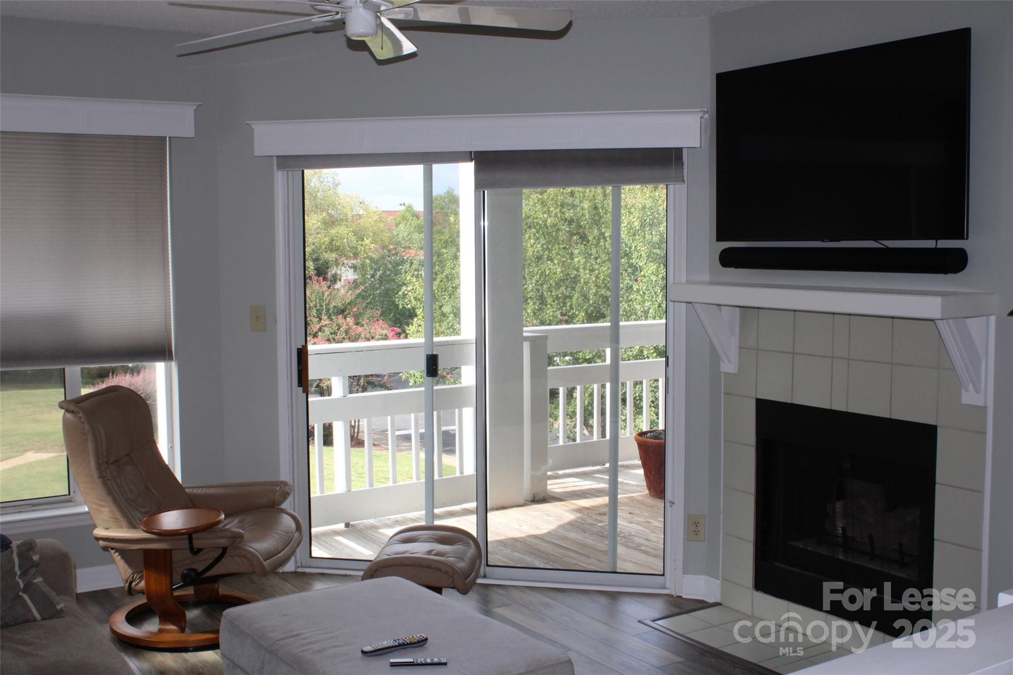 17919 Kings Point Drive, Unit E Cornelius, NC 28031 - Photo 12 of 30 a living room with furniture a flat screen tv and a fireplace