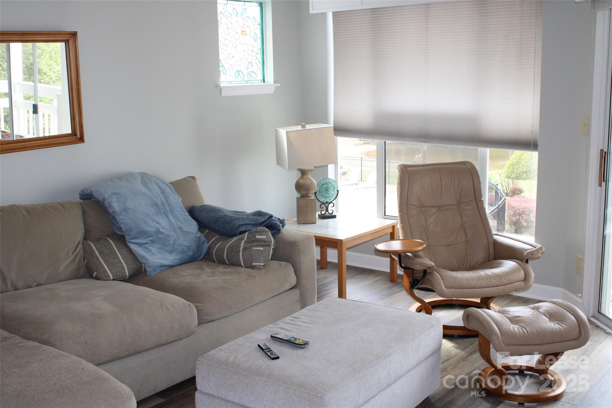 17919 Kings Point Drive, Unit E Cornelius, NC 28031 - Photo 13 of 30 a living room with furniture and a window
