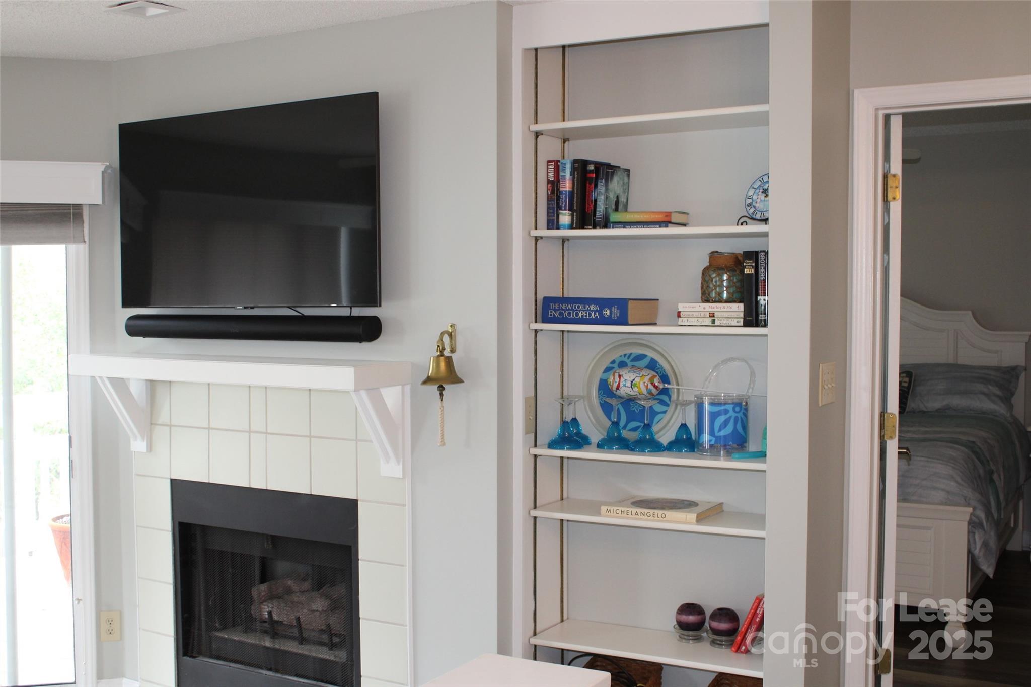 17919 Kings Point Drive, Unit E Cornelius, NC 28031 - Photo 14 of 30 a living room with painting on the wall and a fireplace