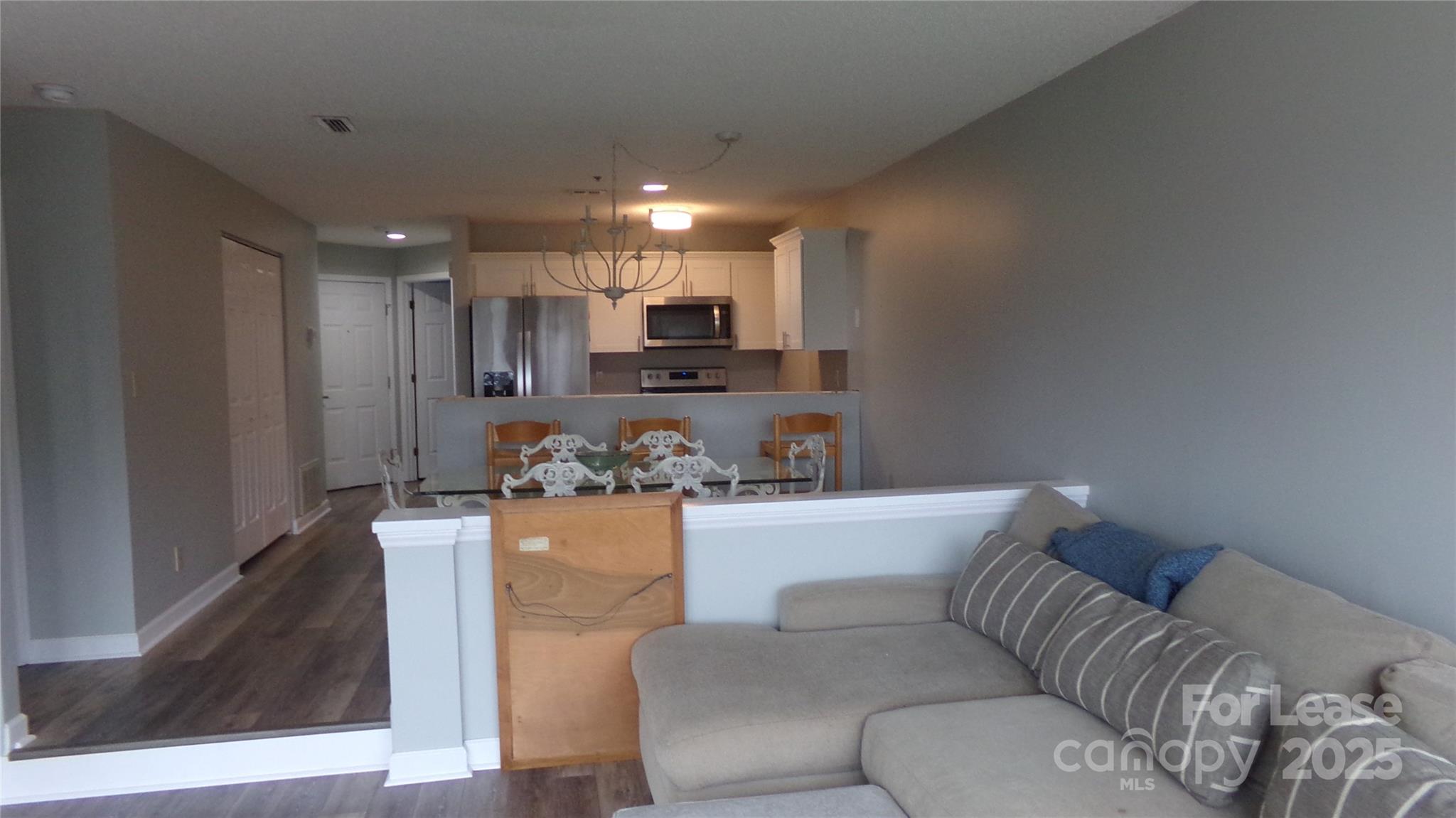 17919 Kings Point Drive, Unit E Cornelius, NC 28031 - Photo 15 of 30 a living room with furniture and a kitchen