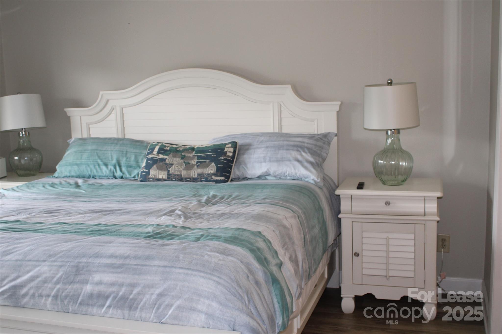 17919 Kings Point Drive, Unit E Cornelius, NC 28031 - Photo 16 of 30 a bedroom with a bed and a night stand