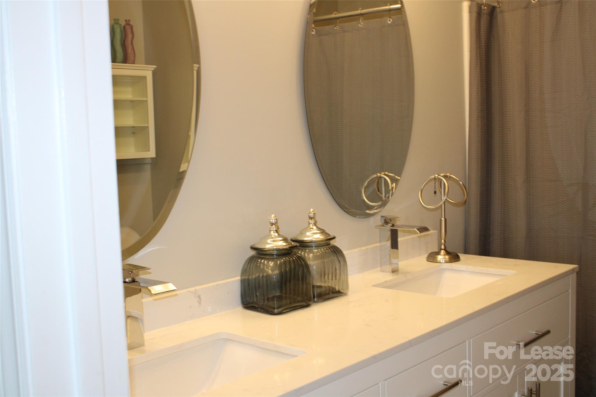 17919 Kings Point Drive, Unit E Cornelius, NC 28031 - Photo 19 of 30 a bathroom with a sink and a mirror