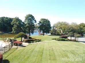 17919 Kings Point Drive, Unit E Cornelius, NC 28031 - Photo 25 of 30 a view of swimming pool with lawn chairs and large trees