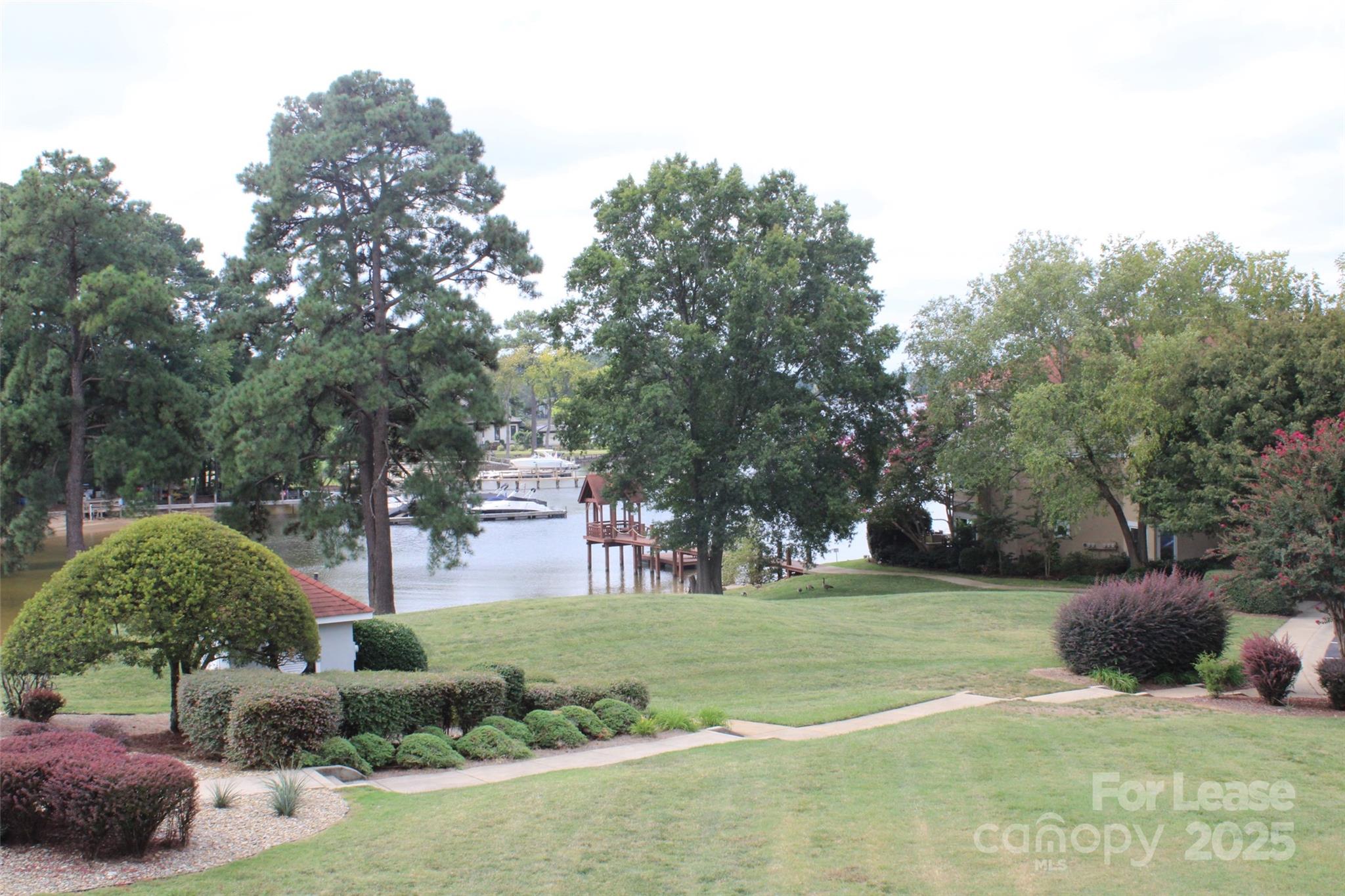 17919 Kings Point Drive, Unit E Cornelius, NC 28031 - Photo 26 of 30 a view of a park with large trees