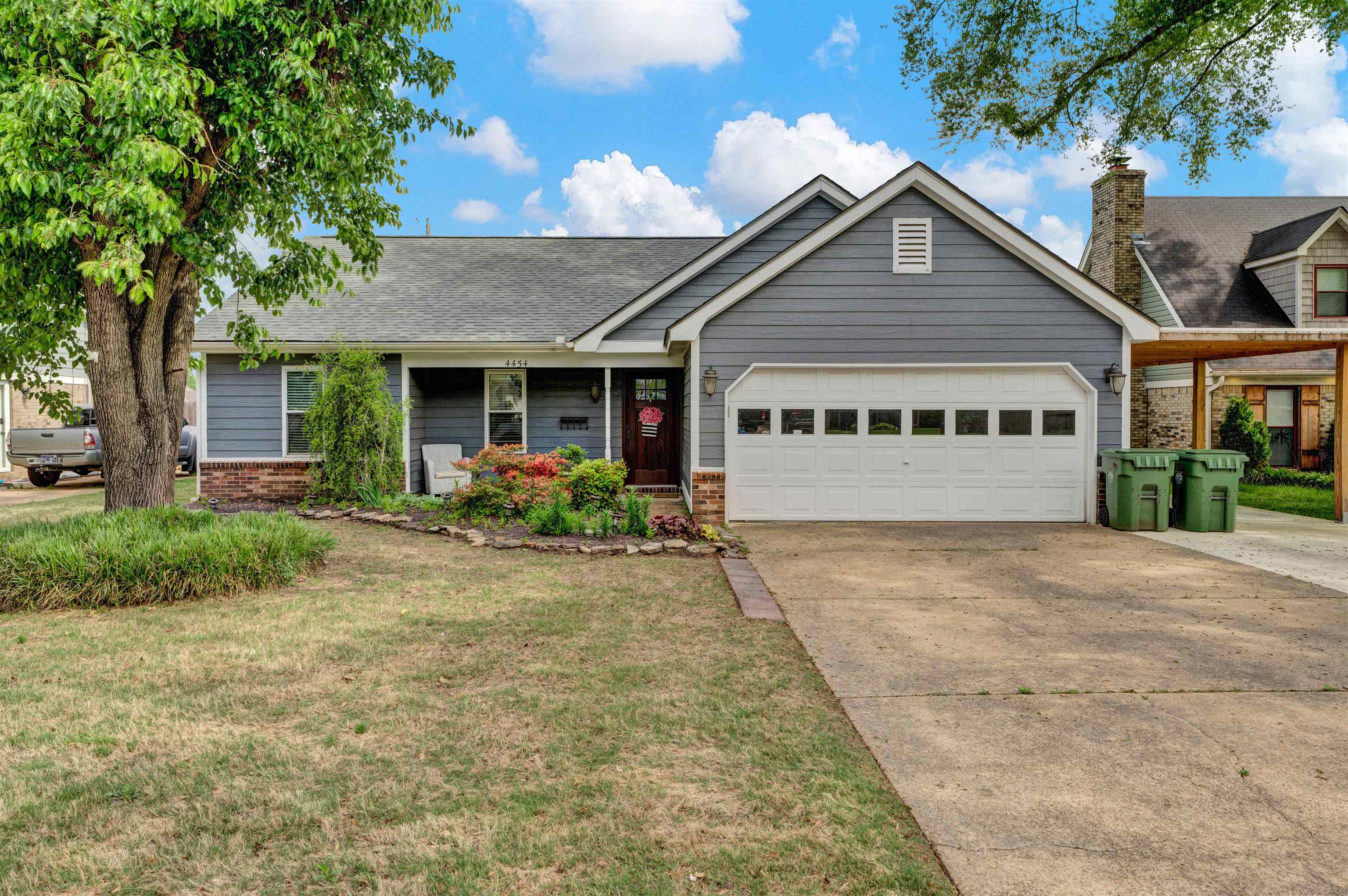4454 Logans Path Road Millington, TN 38053 - Photo 1 of 2 View of front of property featuring a front lawn, a shingled roof, driveway, brick siding, and an attached garage