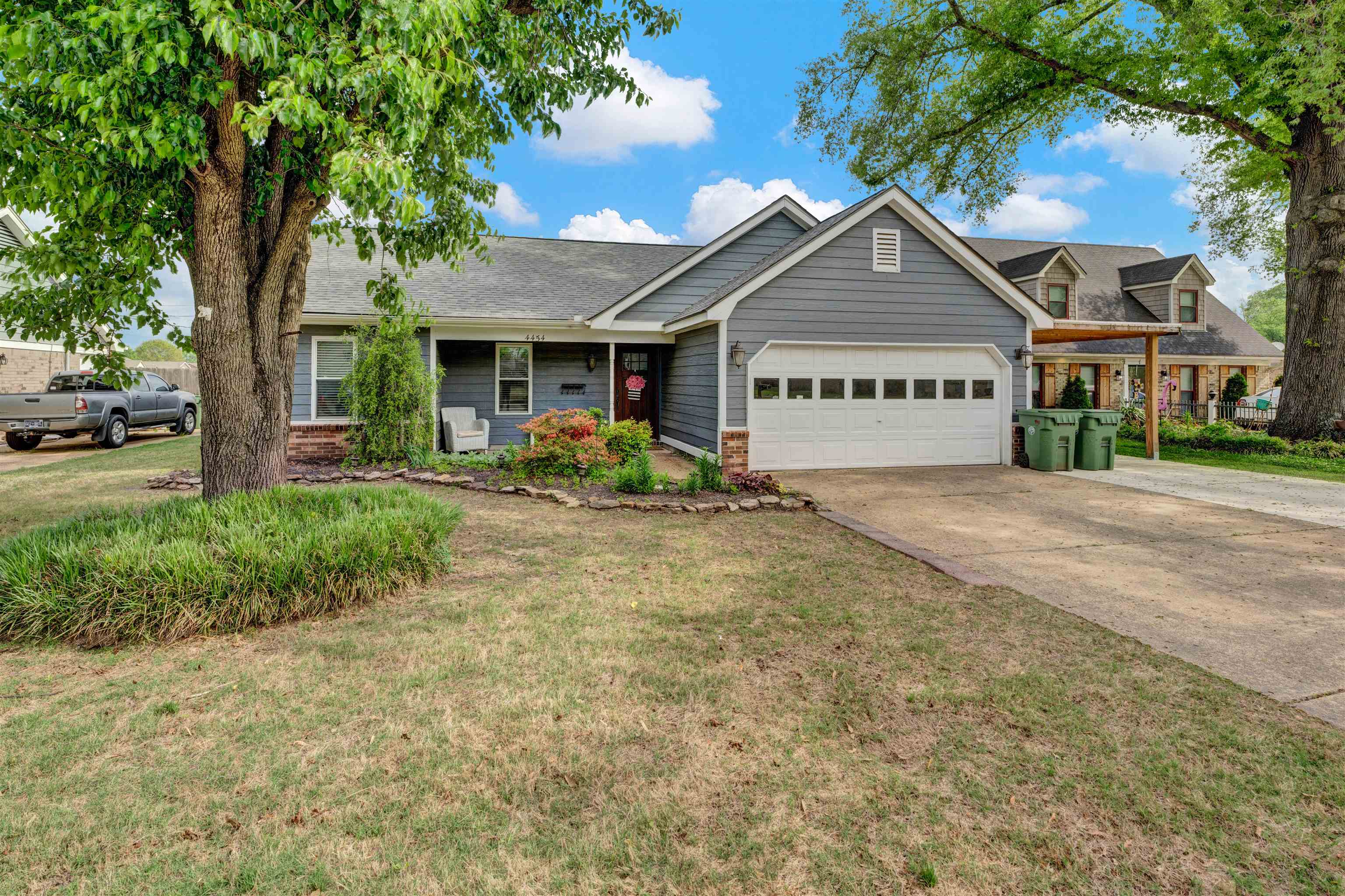 4454 Logans Path Road Millington, TN 38053 - Photo 2 of 2 View of front of property featuring a front yard, an attached garage, concrete driveway, and brick siding