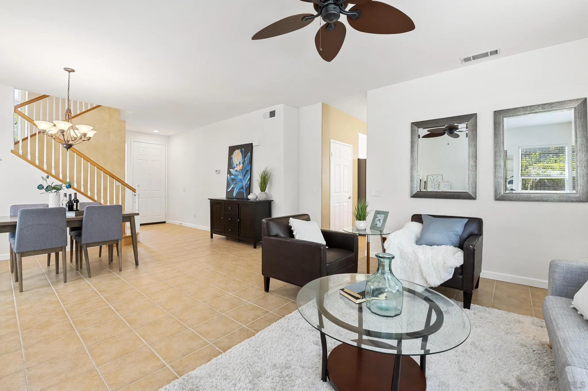 614 Compass Court Carlsbad, CA 92011 - Photo 13 of 33 a living room with furniture a dining table and a chandelier