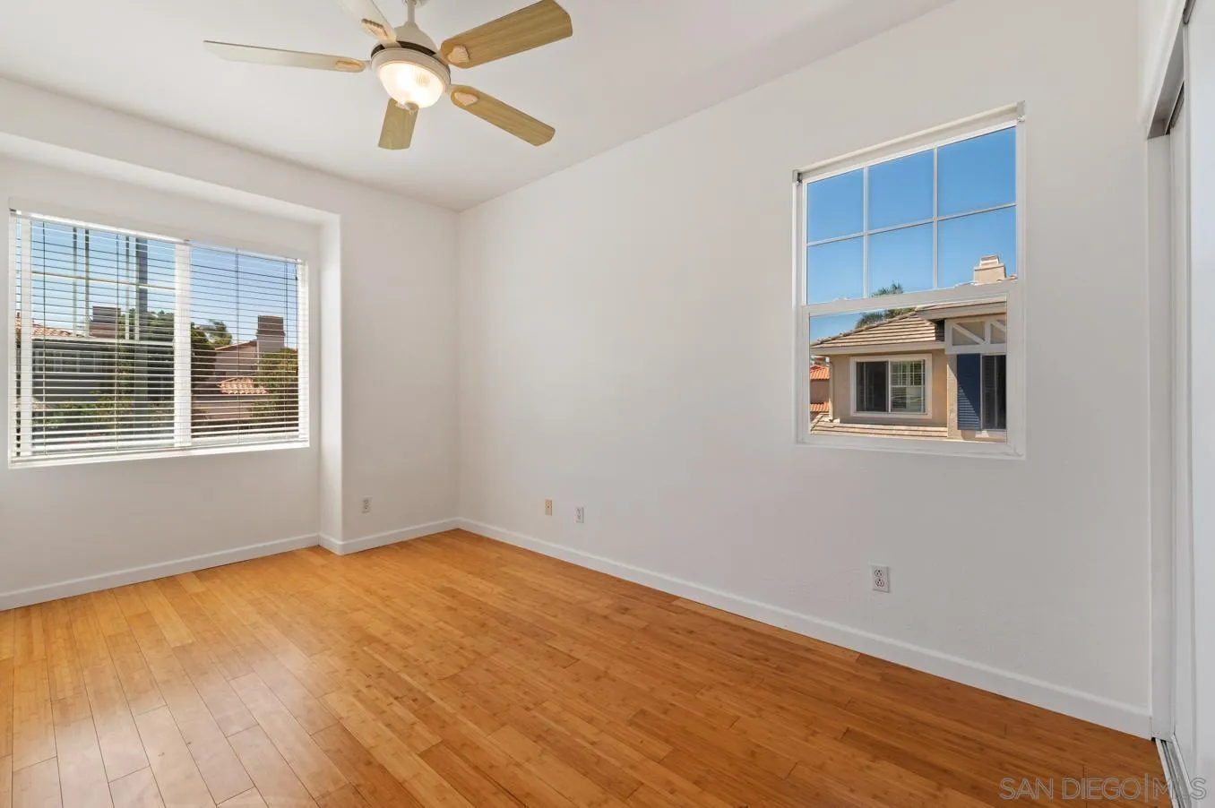 614 Compass Court Carlsbad, CA 92011 - Photo 24 of 33 a view of empty room with wooden floor and fan