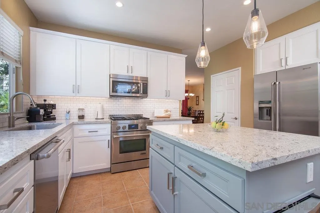 614 Compass Court Carlsbad, CA 92011 - Photo 7 of 33 a kitchen with a stove a sink and a refrigerator
