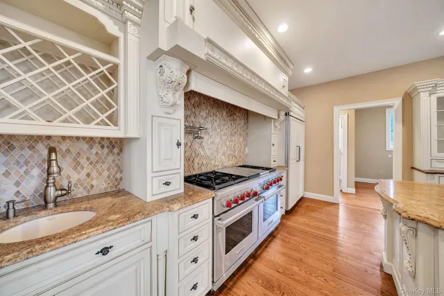 a kitchen with stainless steel appliances granite countertop a stove and a sink
