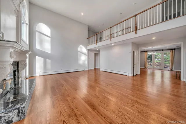a view of an entryway with wooden floor