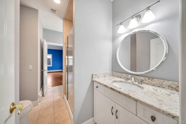 a bathroom with a granite countertop sink and a mirror