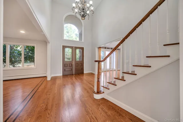 a view of entryway and hall with wooden floor