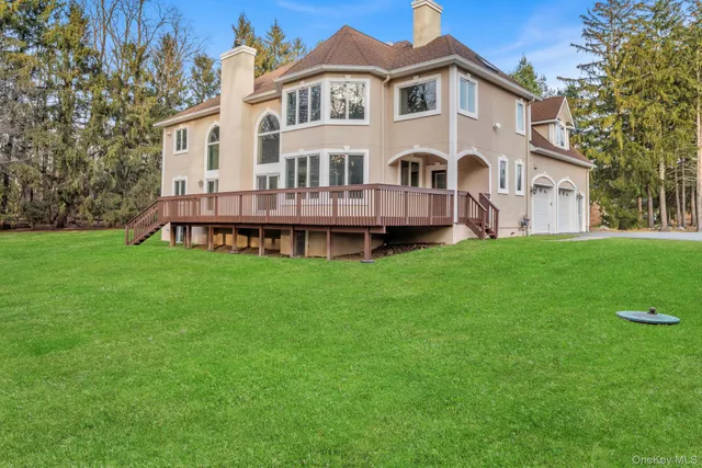 a view of a house with a yard and sitting area