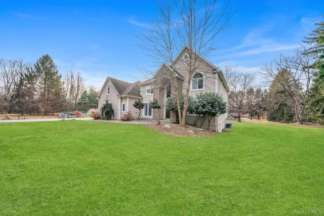 a front view of a house with a garden and plants