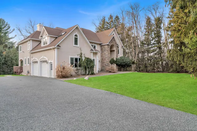 a view of a house with a yard and potted plants