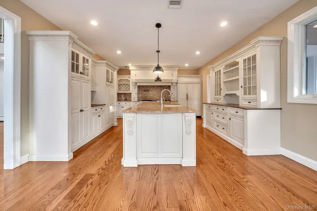 a large kitchen with stainless steel appliances granite countertop a stove and refrigerator