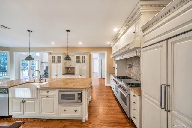 a kitchen with stainless steel appliances granite countertop a stove and a refrigerator