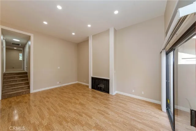 a view of a room with wooden floor and a window
