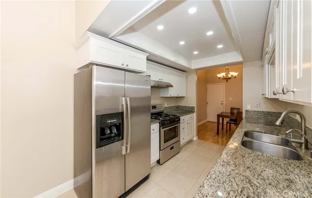 a kitchen with stainless steel appliances granite countertop a stove and a sink