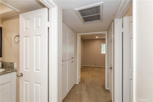 a bathroom with a granite countertop sink toilet a mirror and shower curtain