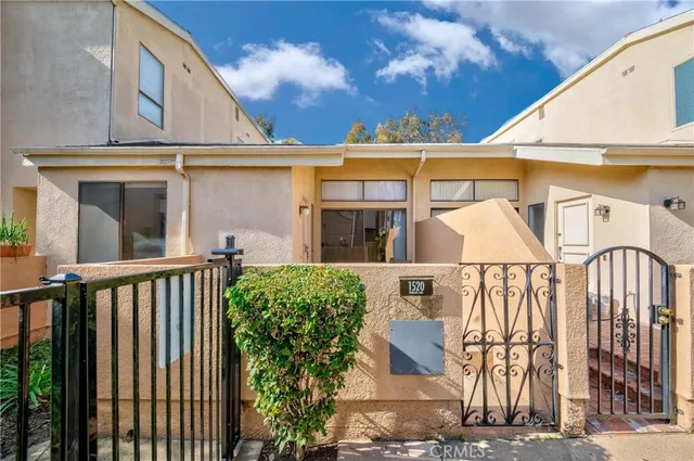 a view of a white house with many windows