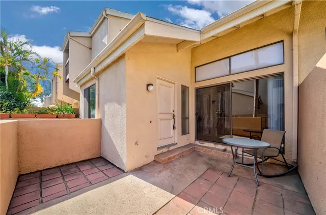 a view of a patio with table and chairs and potted plants