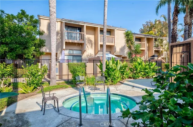 a view of a house with swimming pool and sitting area
