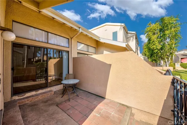 a view of a two chairs and a table in the patio
