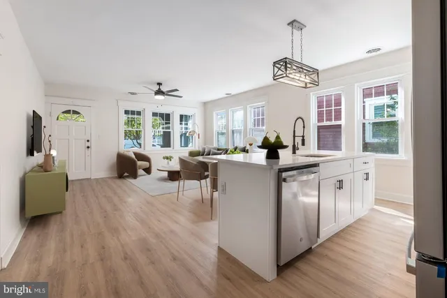 a very nice looking living room with kitchen island furniture and a chandelier