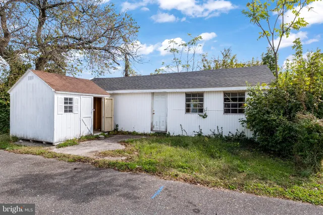 a view of a house with a yard and tree s
