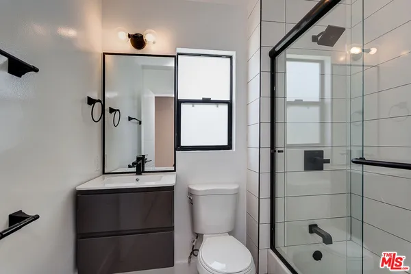 a bathroom with a toilet sink and shower