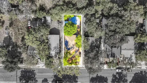 an aerial view of a house with a yard