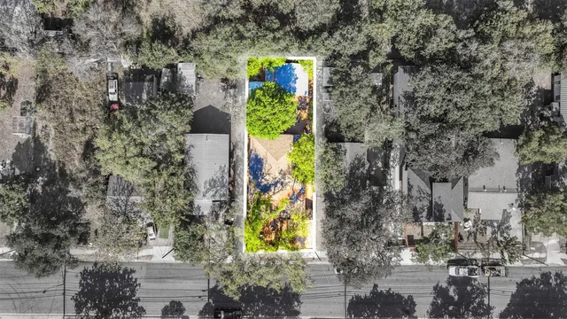 an aerial view of a house with a yard