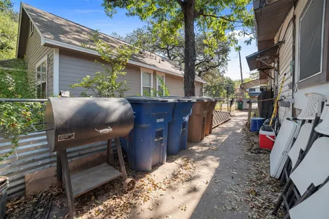 a view of backyard with table and chairs and a barbeque