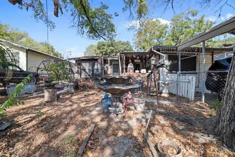 a view of a patio with table and chairs next to a yard