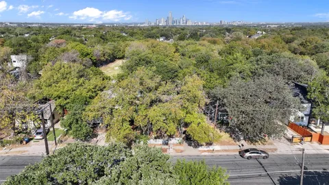 a view of a city with lush green forest