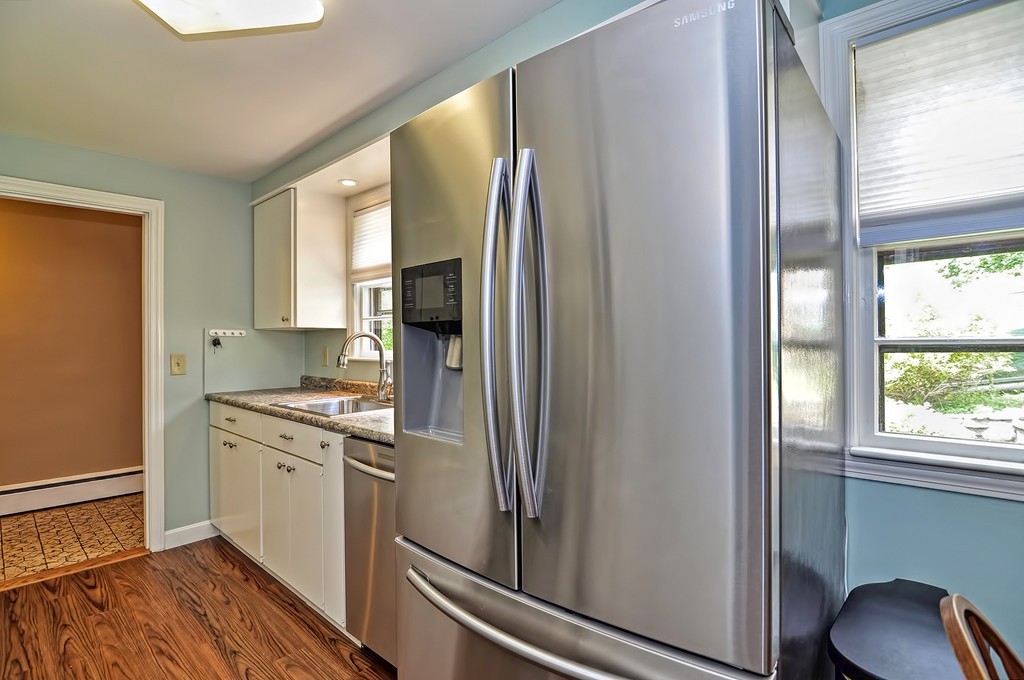 15 Rydal Street Worcester, MA 01602 - Photo 6 of 29 a kitchen with stainless steel appliances granite countertop a refrigerator and a stove
