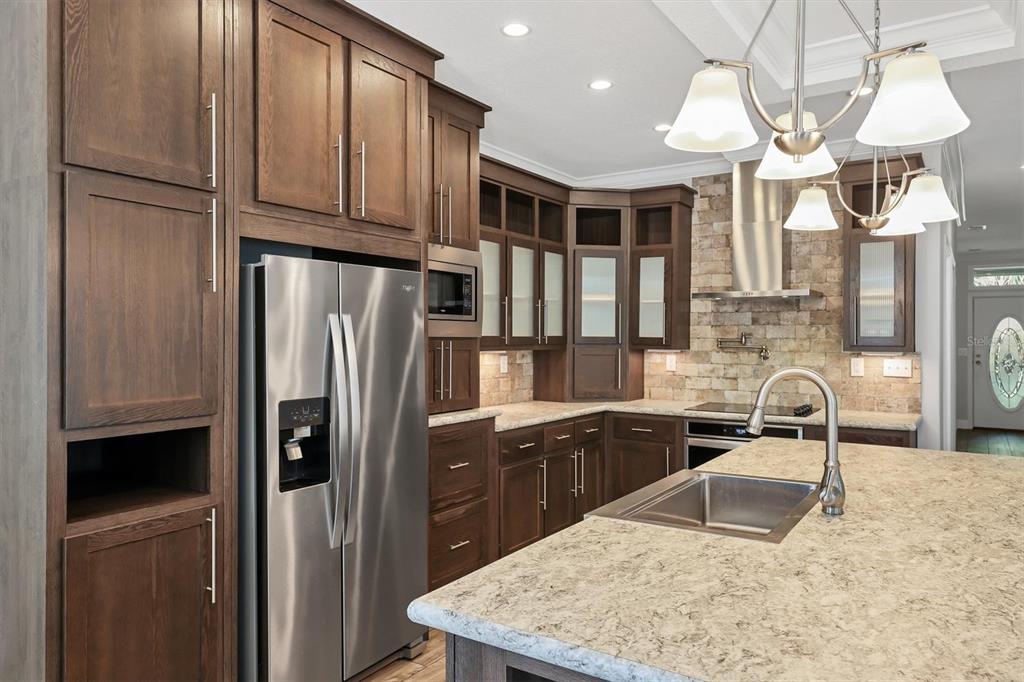 3607 70th Avenue East Ellenton, FL 34222 - Photo 11 of 43 a kitchen with stainless steel appliances granite countertop a refrigerator a sink and a stove