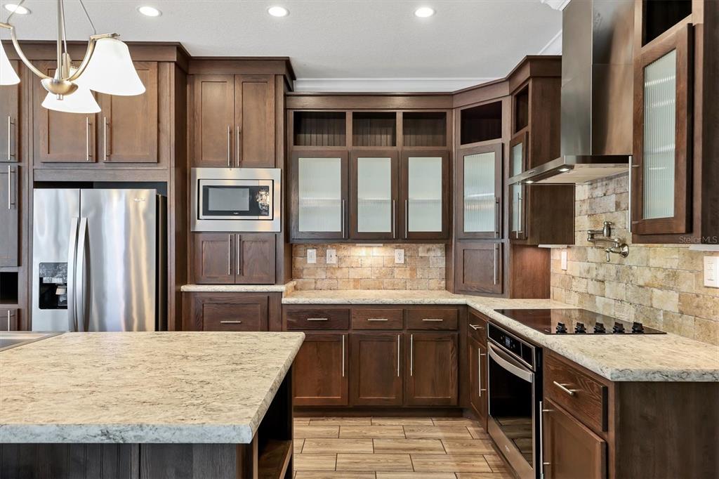 3607 70th Avenue East Ellenton, FL 34222 - Photo 13 of 43 a kitchen with stainless steel appliances granite countertop a stove and a refrigerator