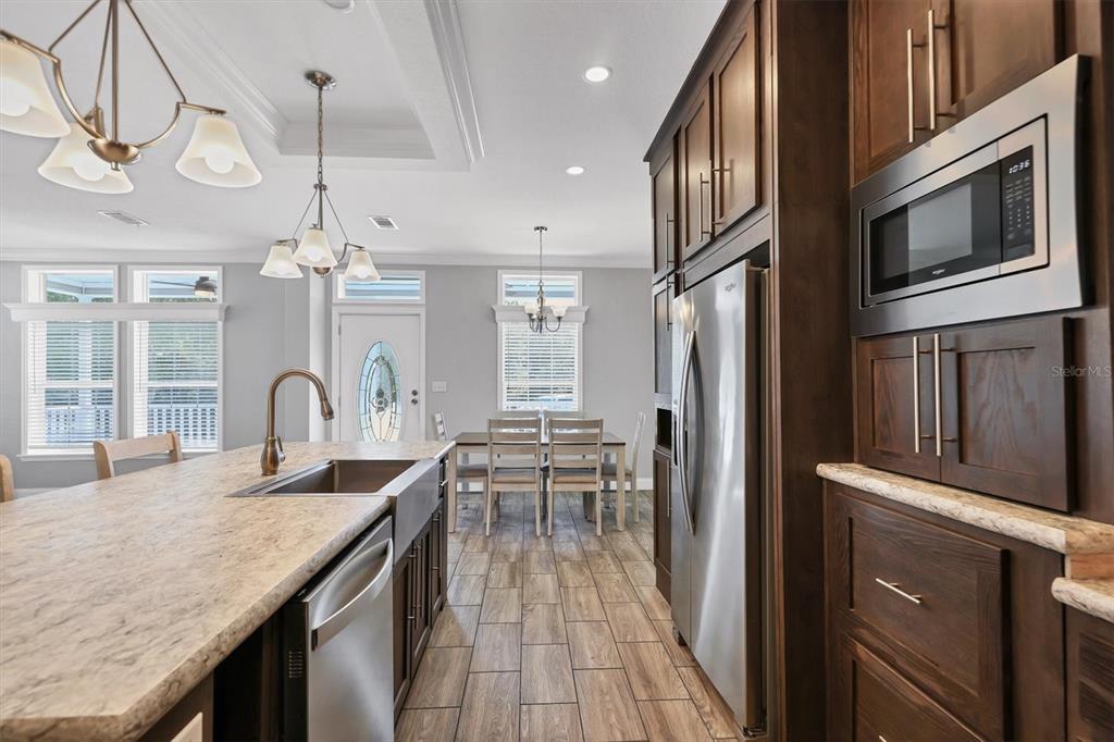 3607 70th Avenue East Ellenton, FL 34222 - Photo 15 of 43 a open kitchen with stainless steel appliances granite countertop a stove and cabinets