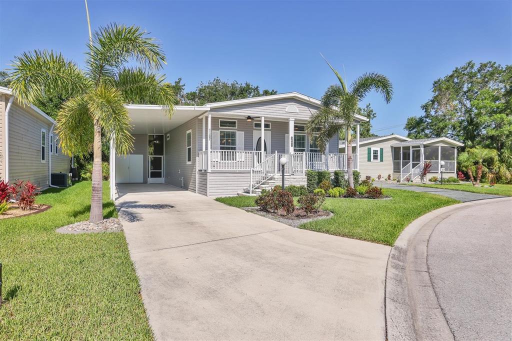 3607 70th Avenue East Ellenton, FL 34222 - Photo 2 of 43 a front view of a house with a garden and plants