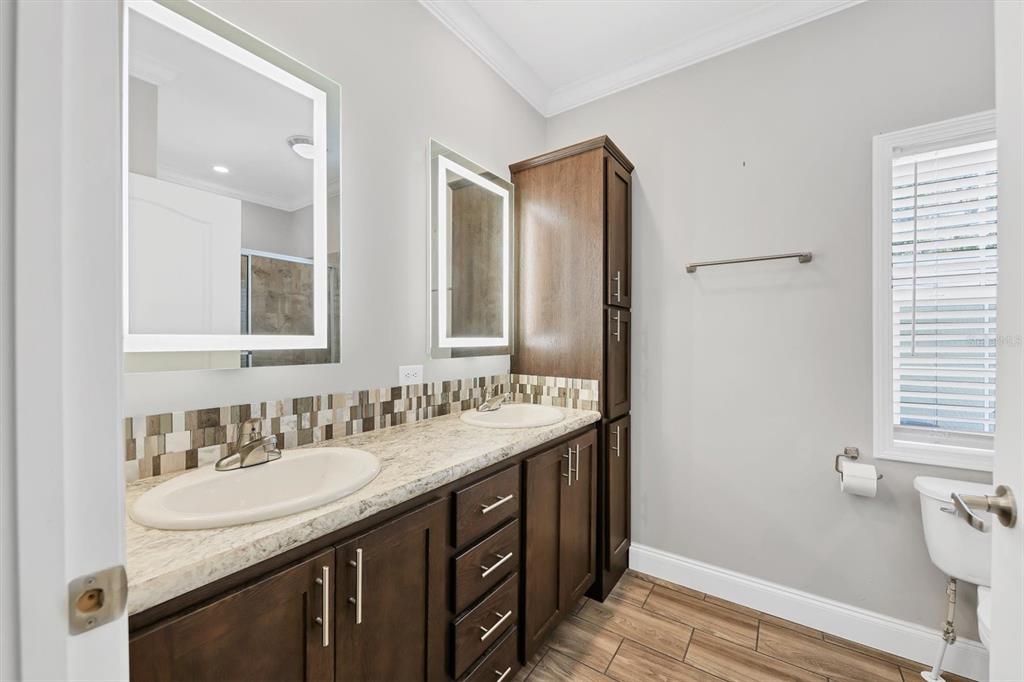 3607 70th Avenue East Ellenton, FL 34222 - Photo 21 of 43 a bathroom with a granite countertop sink and a mirror