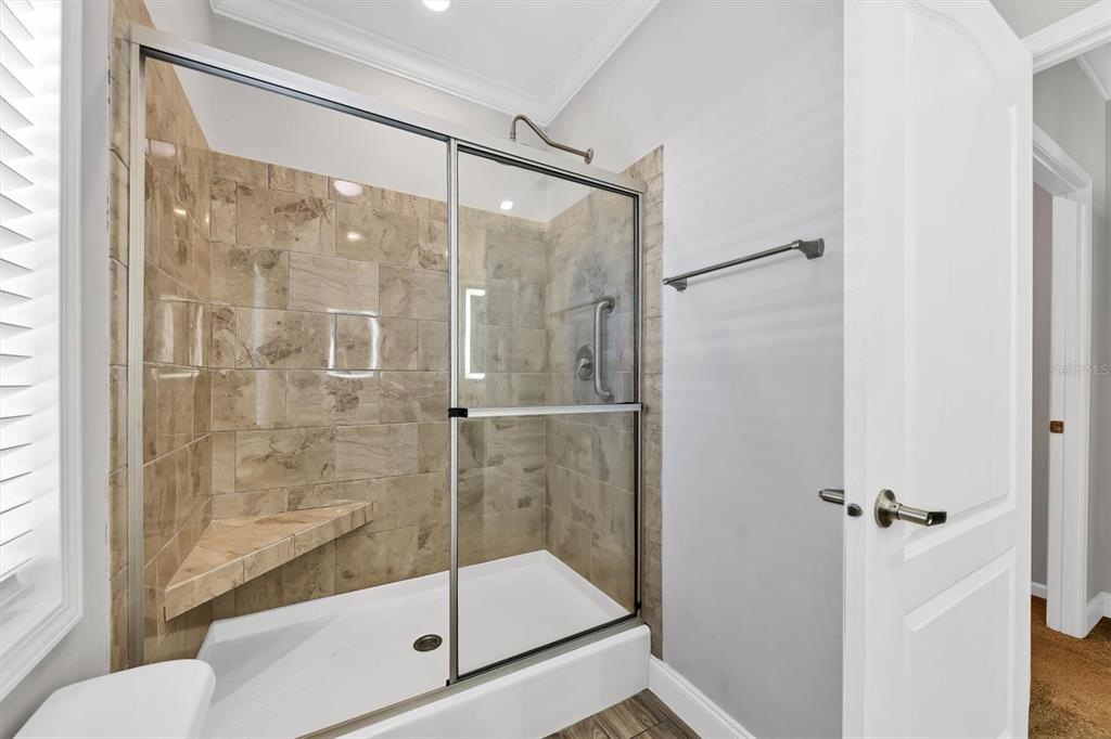 3607 70th Avenue East Ellenton, FL 34222 - Photo 22 of 43 a bathroom with a glass shower door