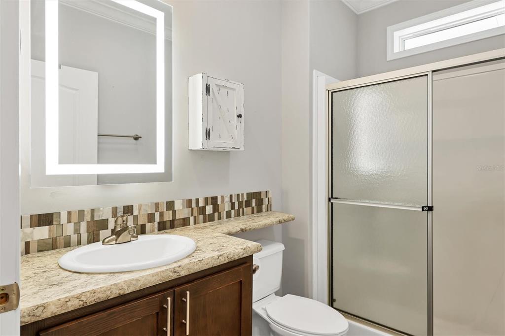 3607 70th Avenue East Ellenton, FL 34222 - Photo 24 of 43 a bathroom with a granite countertop sink toilet and shower