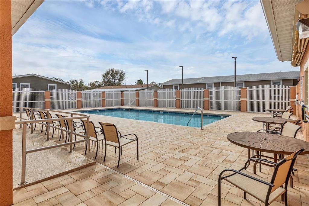 3607 70th Avenue East Ellenton, FL 34222 - Photo 40 of 43 a view of a swimming pool with a patio and a garden