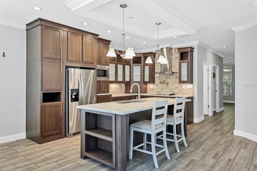 3607 70th Avenue East Ellenton, FL 34222 - Photo 9 of 43 a large kitchen with a table and chairs