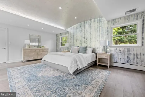a bedroom with a large bed and a dresser
