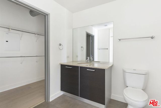 a bathroom with a toilet a sink and a mirror